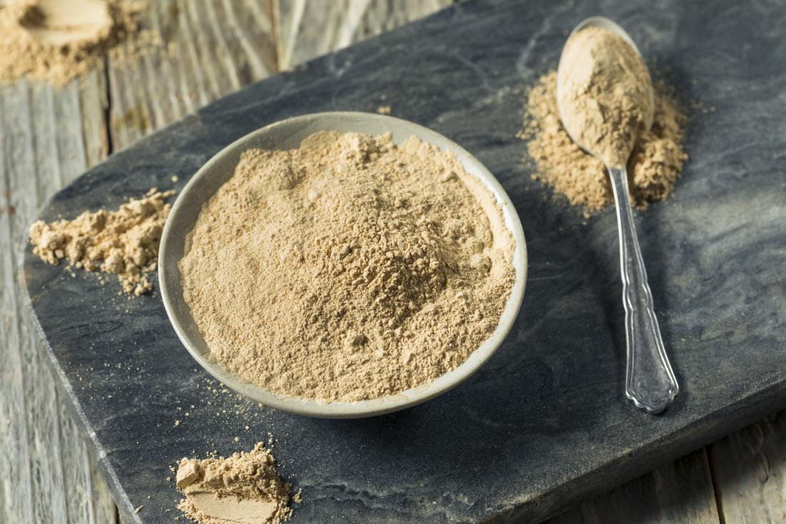 Maca powder in bowl on slate