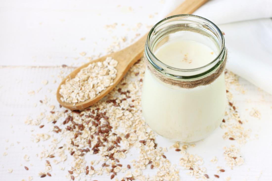 Oat milk and flaxseed on table