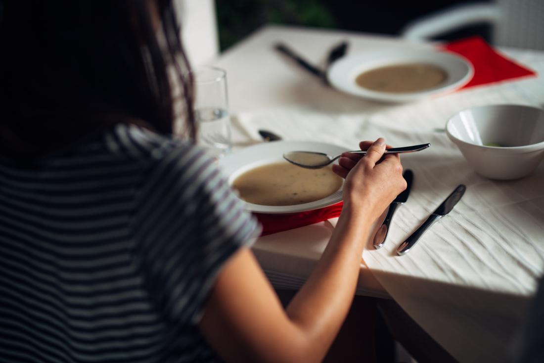 Woman eating bone broth