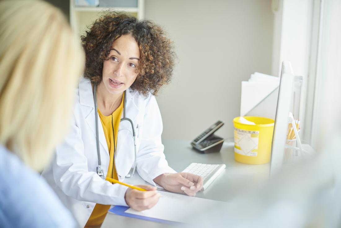 Female doctor in office speaking to patient