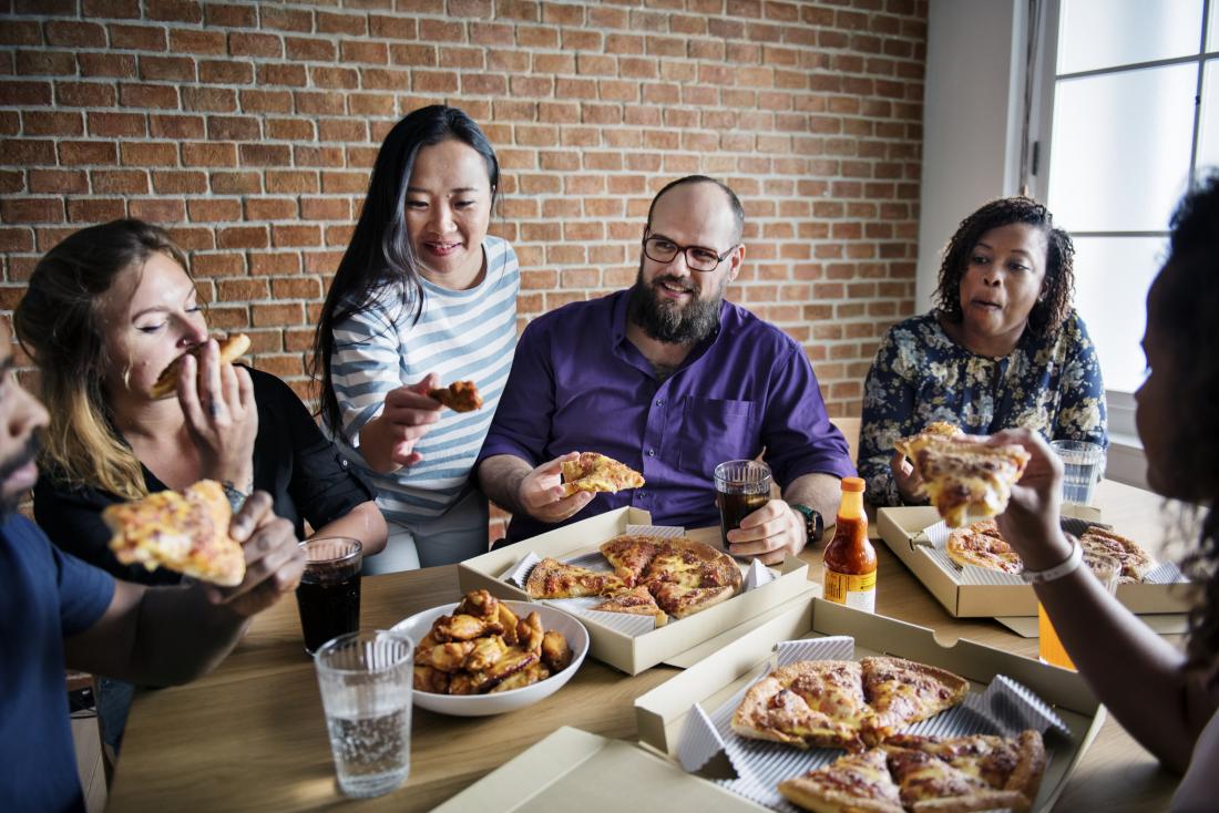 group of friends eating pizza