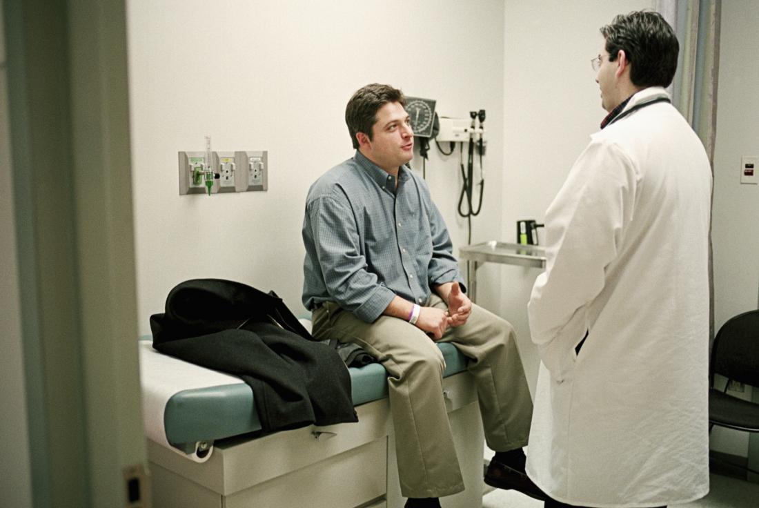 Man sitting on examination bed in doctor's office
