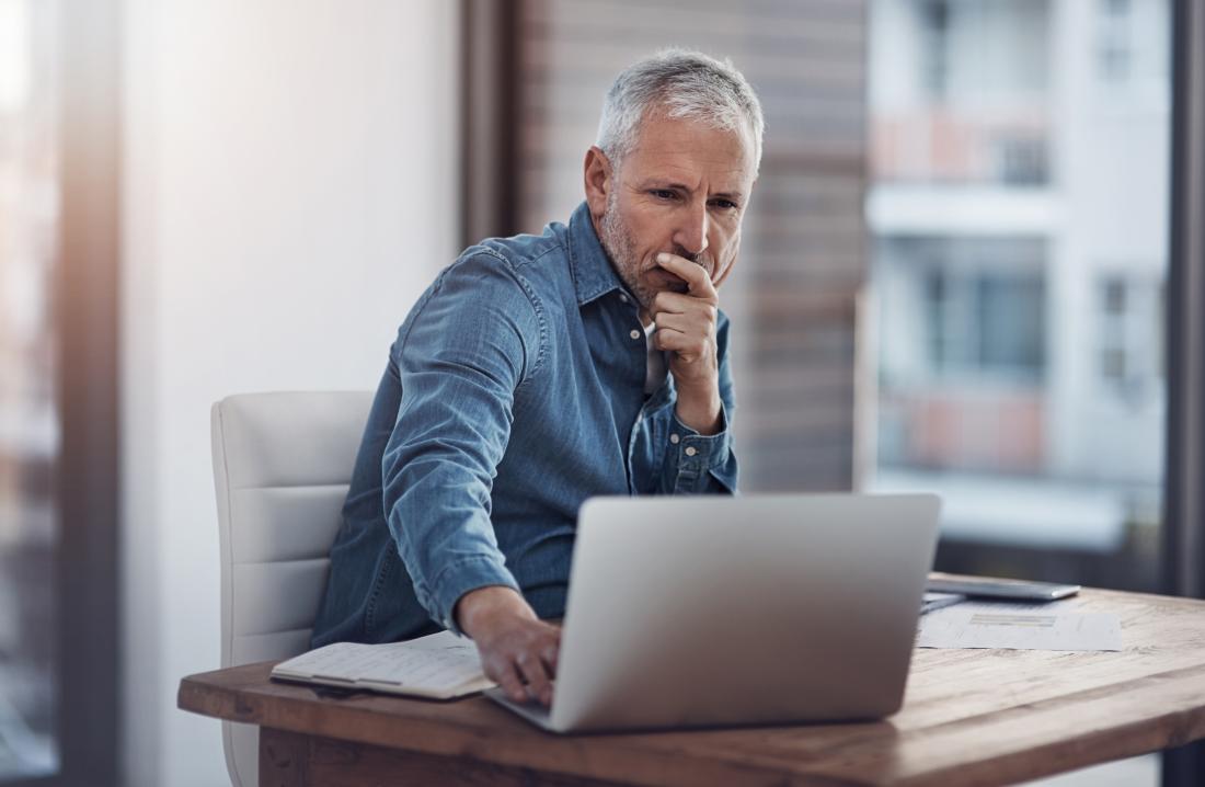 mature man working at laptop