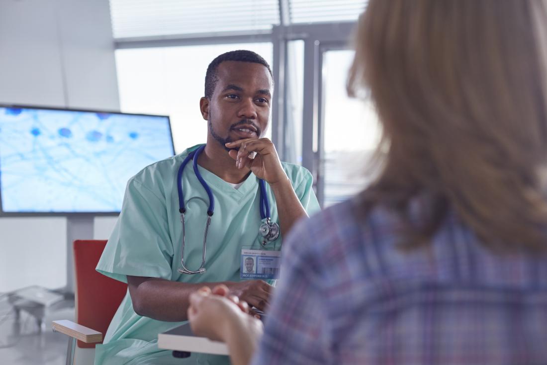 Doctor or surgeon speaking to female patient